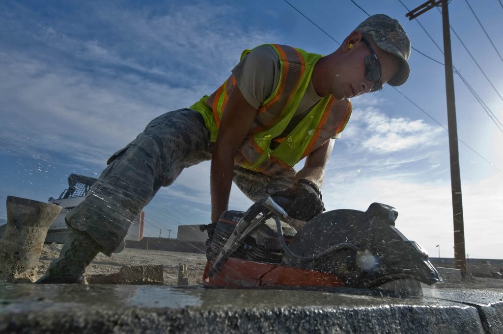 Lubbock Concrete Repair And Leveling worker cutting concrete